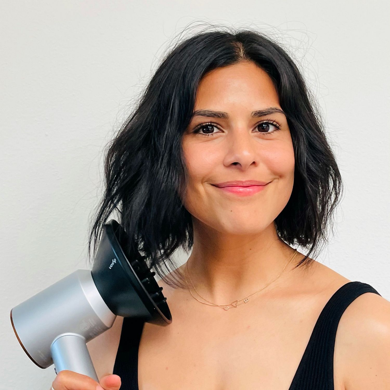 model wearing a french bob hair style with Dyson supersonic